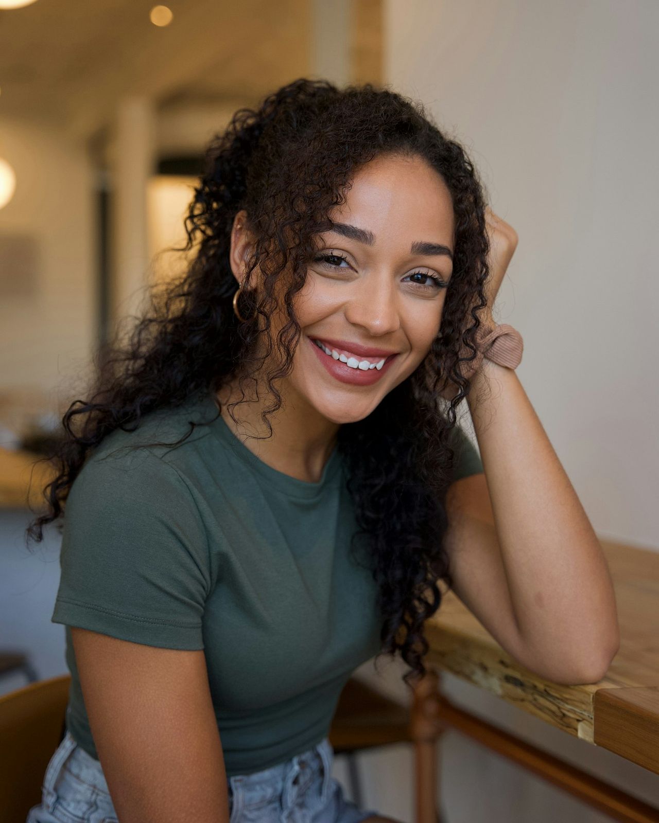 A smiling woman with curly hair